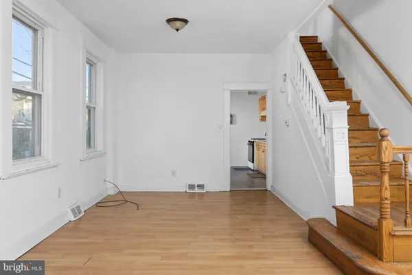 a view of empty room with wooden floor