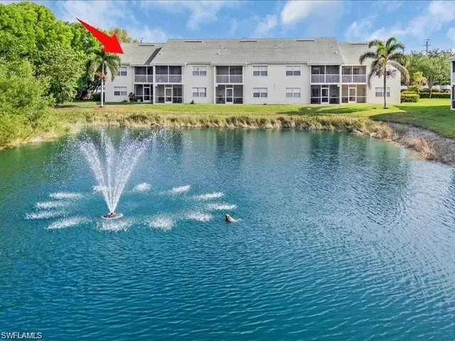 a view of building with river in front of it