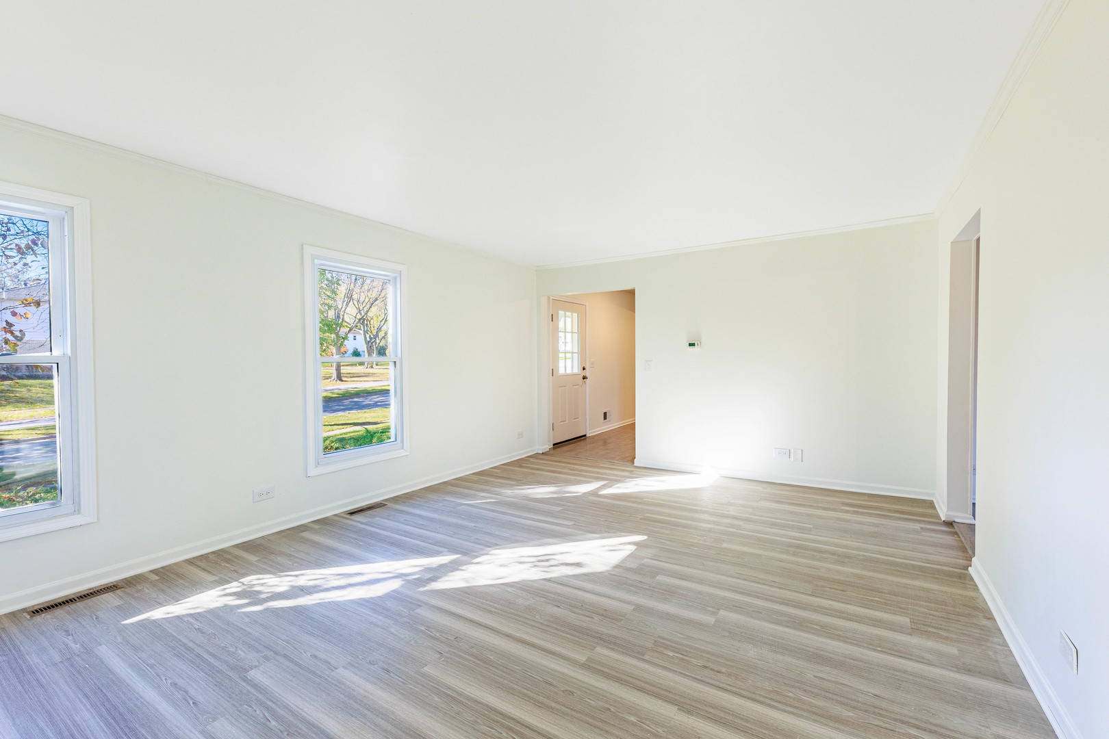 1224 West Whytecliff Road Palatine, IL 60067 - Photo 12 of 50 a view of an empty room with wooden floor and a window