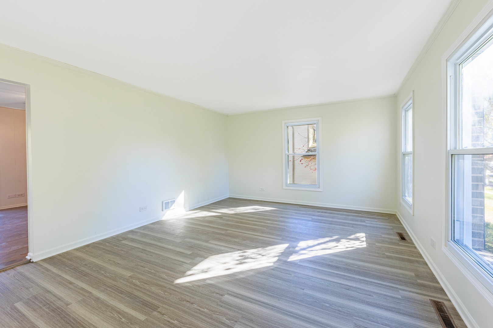 1224 West Whytecliff Road Palatine, IL 60067 - Photo 14 of 50 a view of empty room with wooden floor and fan