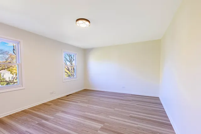 an empty room with windows and closet