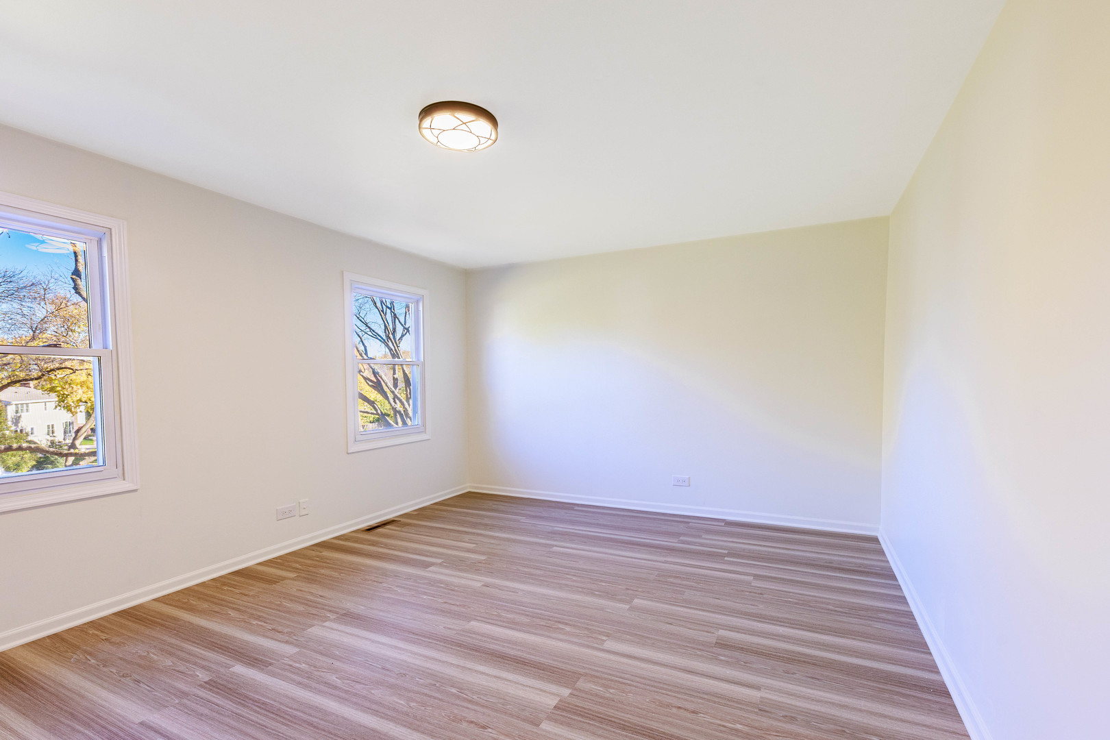 1224 West Whytecliff Road Palatine, IL 60067 - Photo 30 of 50 a view of an empty room with wooden floor and a window