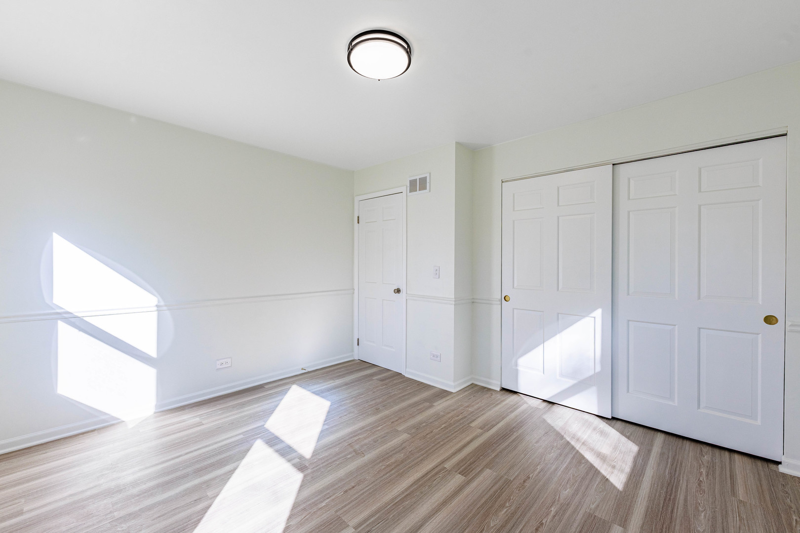 1224 West Whytecliff Road Palatine, IL 60067 - Photo 35 of 50 a view of empty room with wooden floor and fan