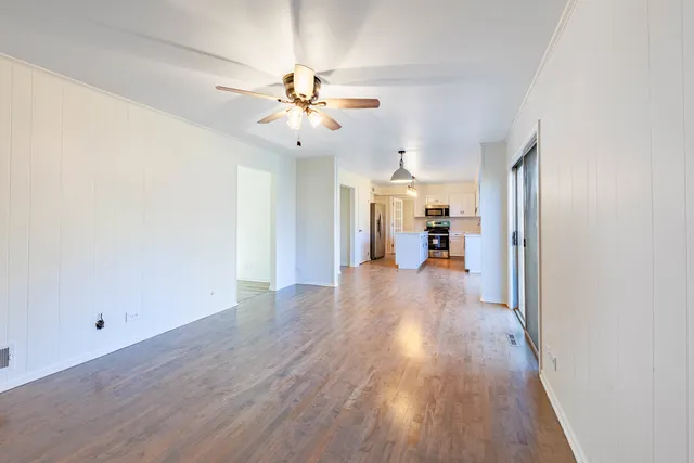 a view of a room with wooden floor