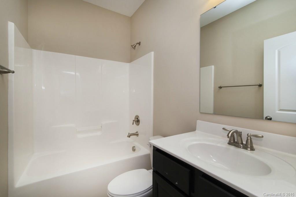 710 Old Cove Road, Unit 42 Tega Cay, SC 29708 - Photo 13 of 23 a bathroom with a sink toilet vanity and bathtub