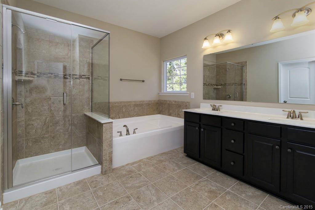 710 Old Cove Road, Unit 42 Tega Cay, SC 29708 - Photo 15 of 23 a spacious bathroom with a tub sink shower and mirror