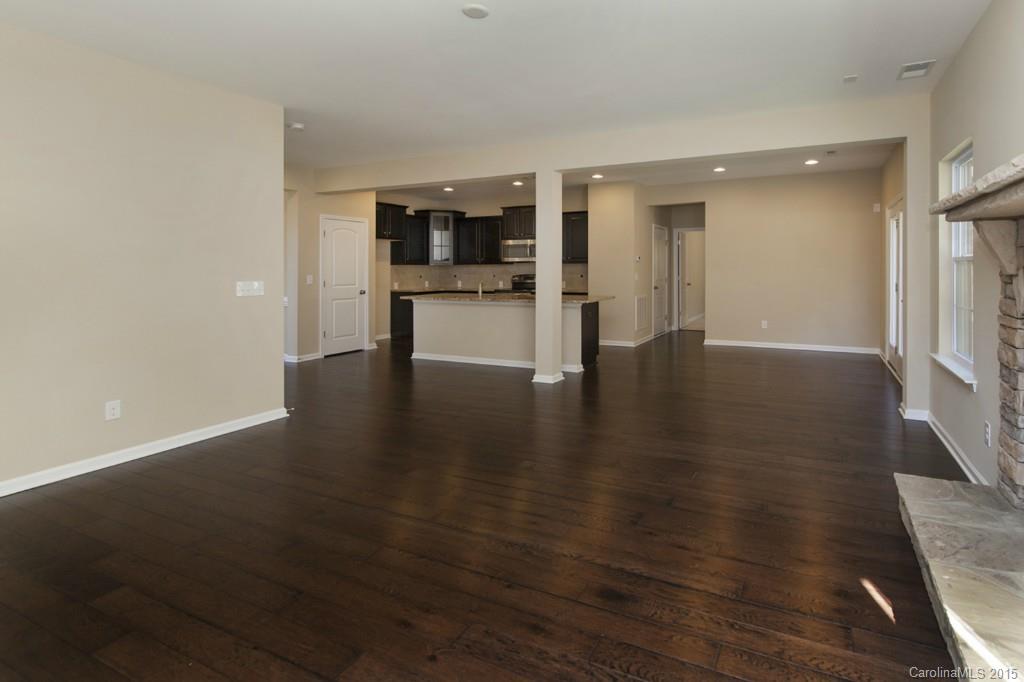 710 Old Cove Road, Unit 42 Tega Cay, SC 29708 - Photo 4 of 23 a view of empty room with wooden floor and windows