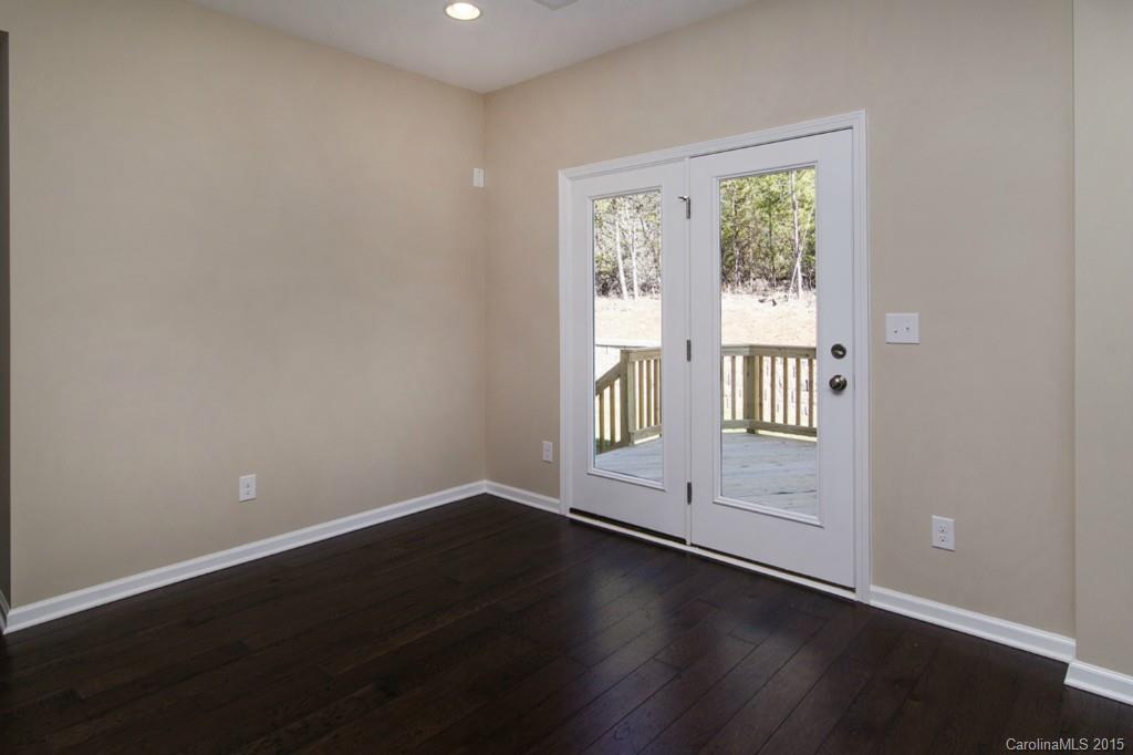 710 Old Cove Road, Unit 42 Tega Cay, SC 29708 - Photo 6 of 23 a view of an empty room with wooden floor and a window