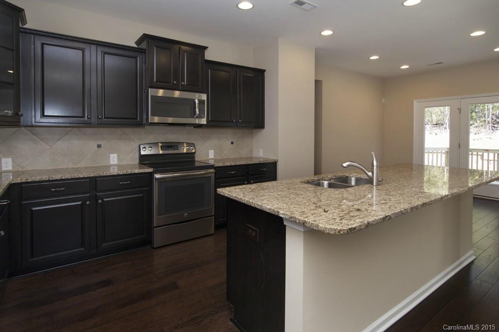 710 Old Cove Road, Unit 42 Tega Cay, SC 29708 - Photo 8 of 23 a kitchen with stainless steel appliances granite countertop a sink stove and microwave