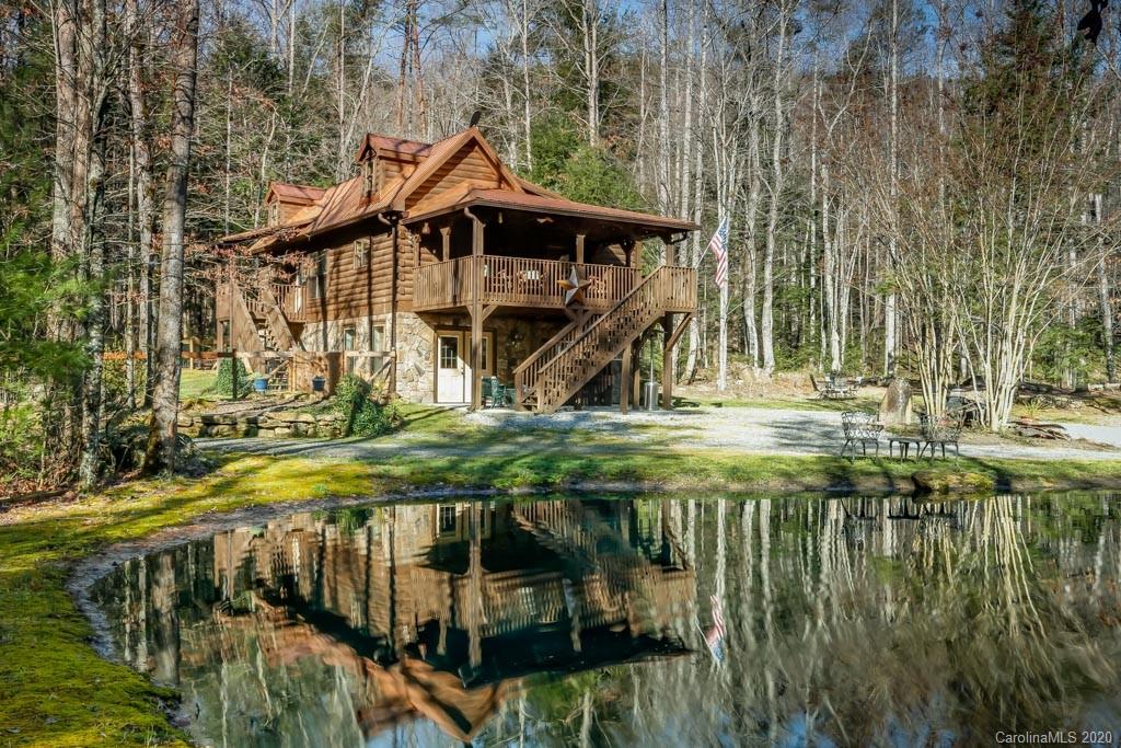 997 Proctor Road Lake Lure, NC 28746 - Photo 1 of 40 a yellow house with trees in front of it