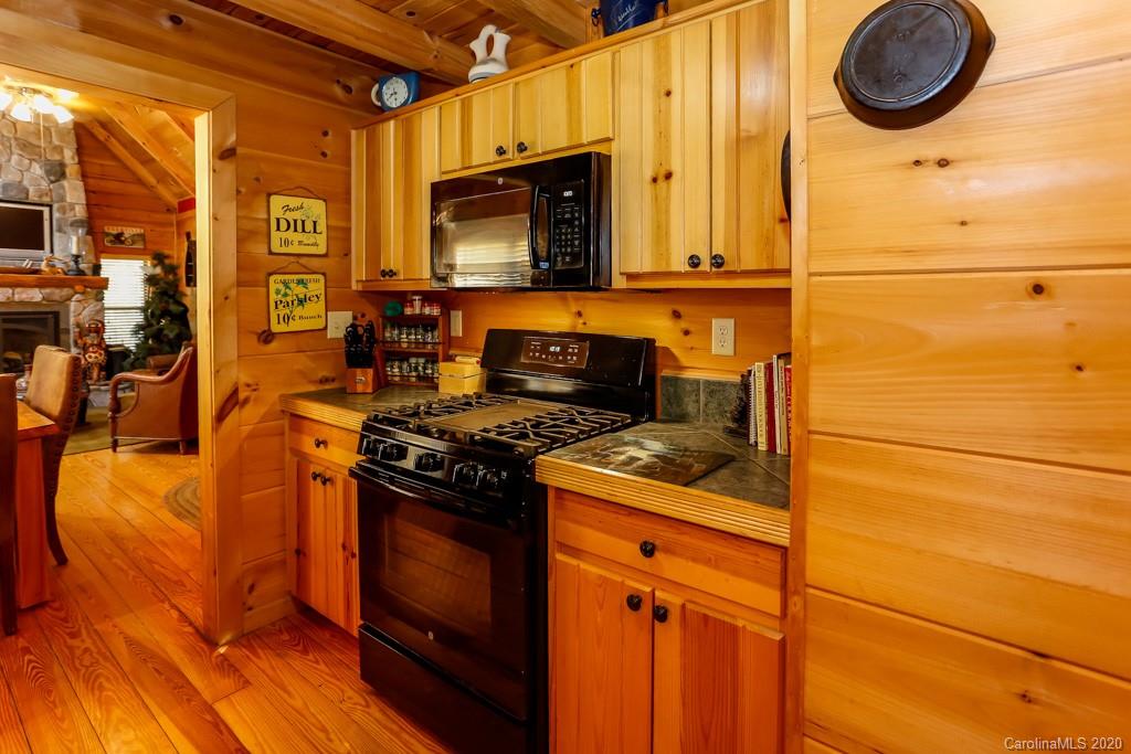997 Proctor Road Lake Lure, NC 28746 - Photo 11 of 40 a kitchen with a stove and a microwave