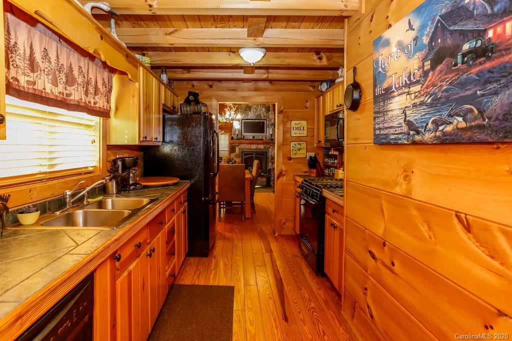 997 Proctor Road Lake Lure, NC 28746 - Photo 12 of 40 a view of a balcony with wooden floor and brick walls