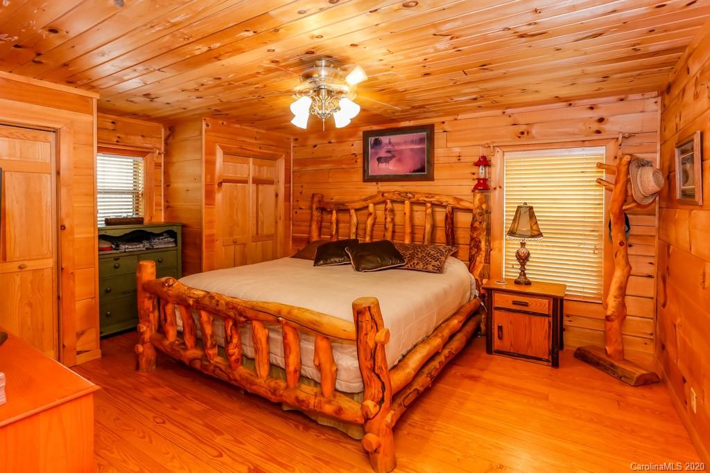997 Proctor Road Lake Lure, NC 28746 - Photo 13 of 40 a bed sitting in a spacious bedroom next to a window