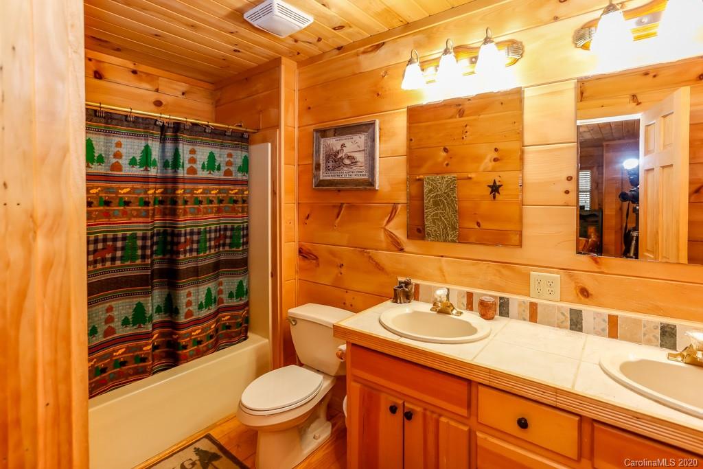 997 Proctor Road Lake Lure, NC 28746 - Photo 14 of 40 a bathroom with a sink a toilet and shower