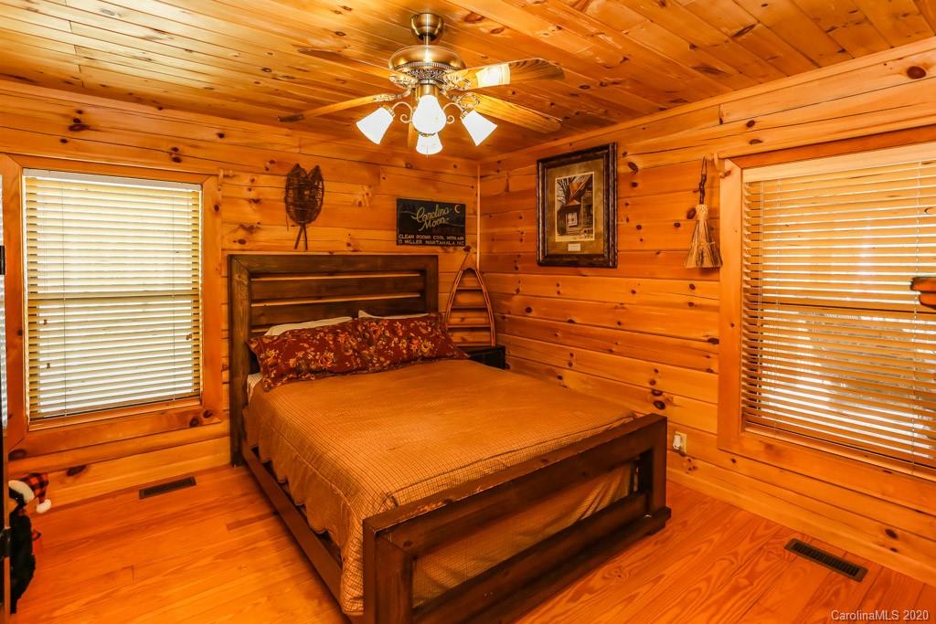 997 Proctor Road Lake Lure, NC 28746 - Photo 15 of 40 a blue bench sitting in front of a house