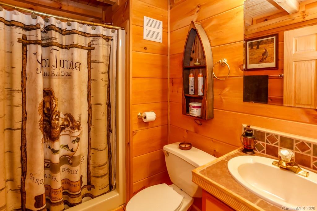997 Proctor Road Lake Lure, NC 28746 - Photo 16 of 40 a bathroom with a sink toilet and shower