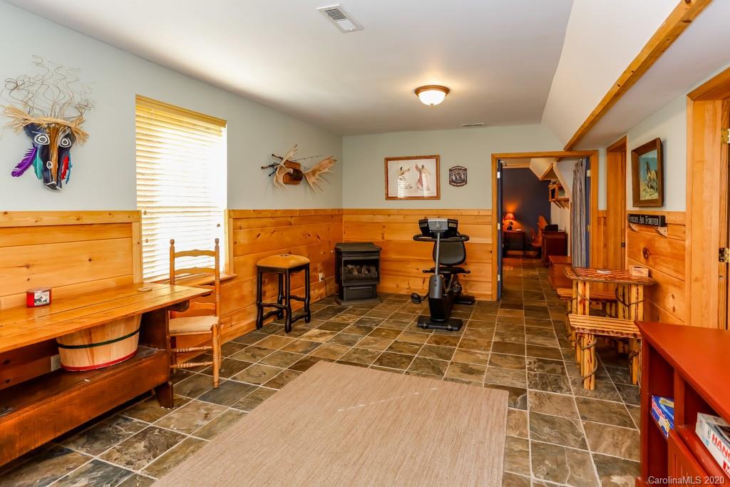 997 Proctor Road Lake Lure, NC 28746 - Photo 18 of 40 a living room with stainless steel appliances kitchen island granite countertop furniture and a rug