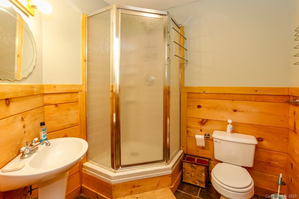 997 Proctor Road Lake Lure, NC 28746 - Photo 19 of 40 a bathroom with a sink mirror vanity and toilet