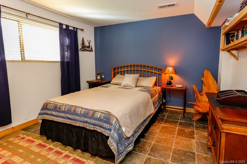 997 Proctor Road Lake Lure, NC 28746 - Photo 20 of 40 a bedroom with a bed and a window