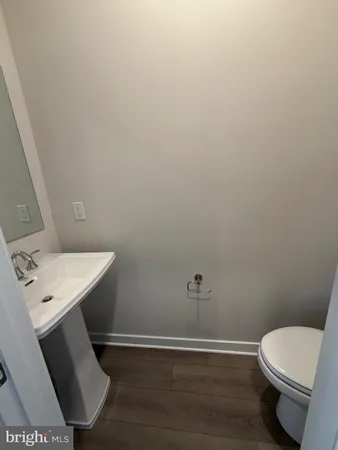 a bathroom with a toilet a sink and mirror