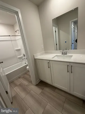 a bathroom with a sink a toilet and mirror