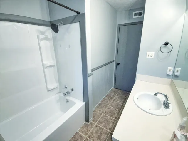 a bathroom with a tub sink and toilet