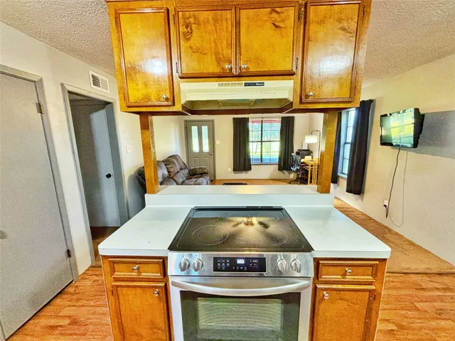 a kitchen with a stove and a refrigerator