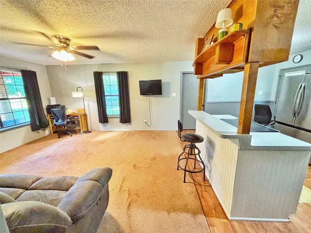 a view of a livingroom with furniture and a flat screen tv