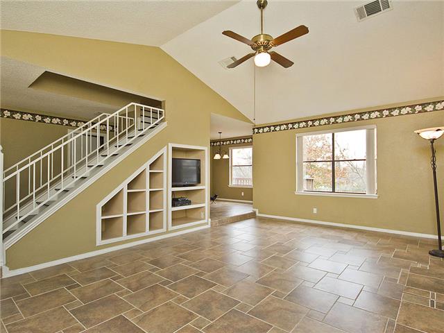 1411 Clearview Loop Round Rock, TX 78664 - Photo 2 of 13 Unfurnished living room with stairs, baseboards, visible vents, a ceiling fan, and high vaulted ceiling