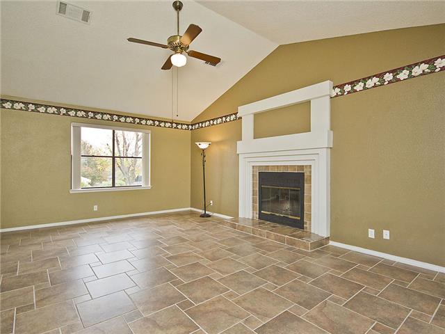 1411 Clearview Loop Round Rock, TX 78664 - Photo 3 of 13 Unfurnished living room featuring a fireplace, visible vents, a ceiling fan, and baseboards