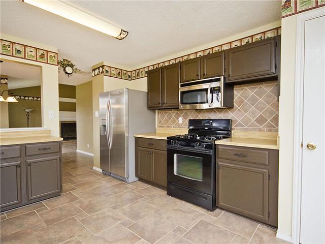 1411 Clearview Loop Round Rock, TX 78664 - Photo 4 of 13 Kitchen featuring tasteful backsplash, stainless steel appliances, light countertops, stone finish flooring, and baseboards