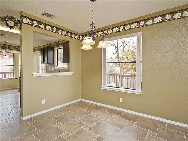 1411 Clearview Loop Round Rock, TX 78664 - Photo 5 of 13 Unfurnished dining area with a wealth of natural light, stone tile flooring, and a notable chandelier