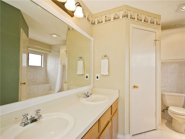 1411 Clearview Loop Round Rock, TX 78664 - Photo 9 of 13 Full bath featuring tile patterned floors, toilet, a shower with shower curtain, and a sink