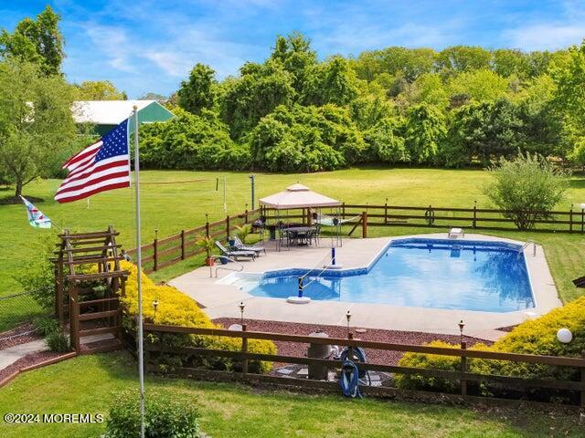 144 Windeler Road Howell, NJ 07731 - Photo 58 of 59 a view of a swimming pool with a patio and a yard