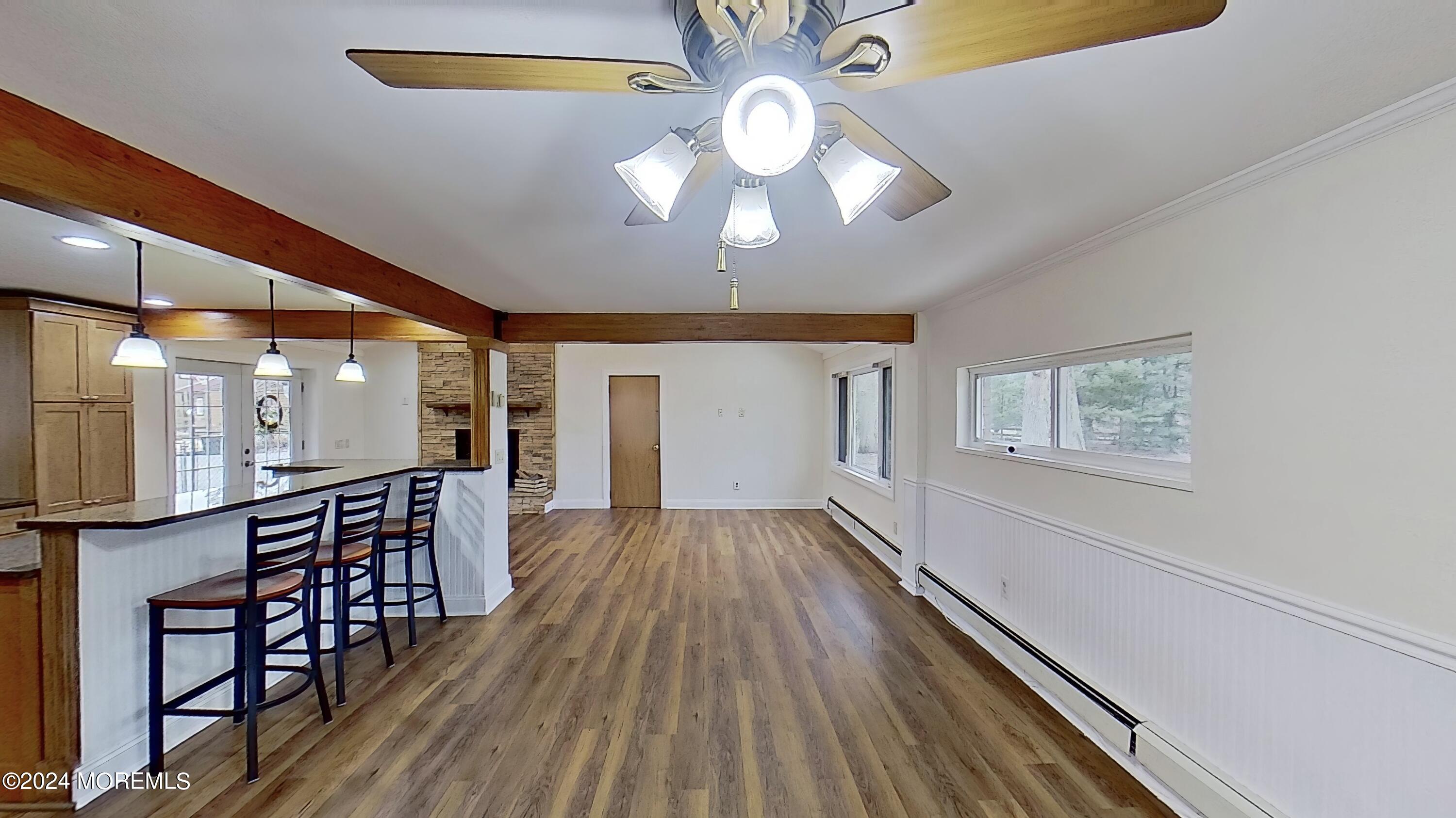 144 Windeler Road Howell, NJ 07731 - Photo 9 of 59 an empty room with wooden floor fan and windows