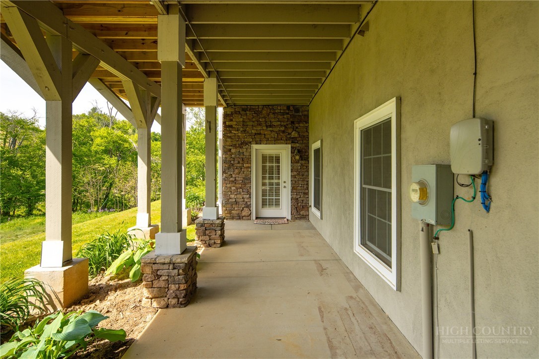 147 Riverside Park Court, Unit G2 Jefferson, NC 28640 - Photo 38 of 44 a view of a porch with chairs