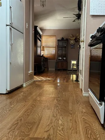 a kitchen with a refrigerator a stove a dining table and chairs