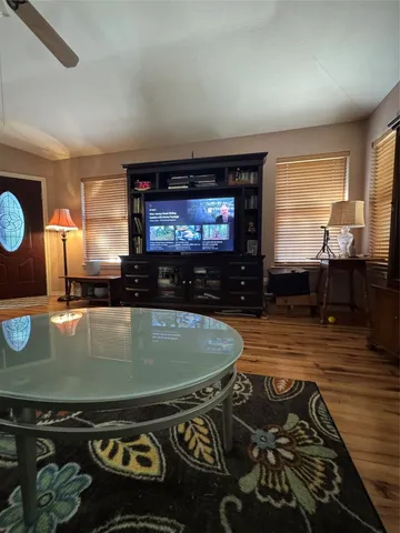 a view of a trees in front of a house with a big yard