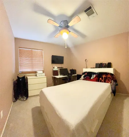 a room with a bed and a television