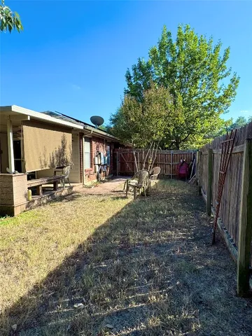 a view of a backyard with sitting area