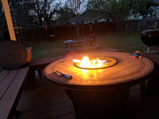 a view of a swimming pool with a dining table and chairs