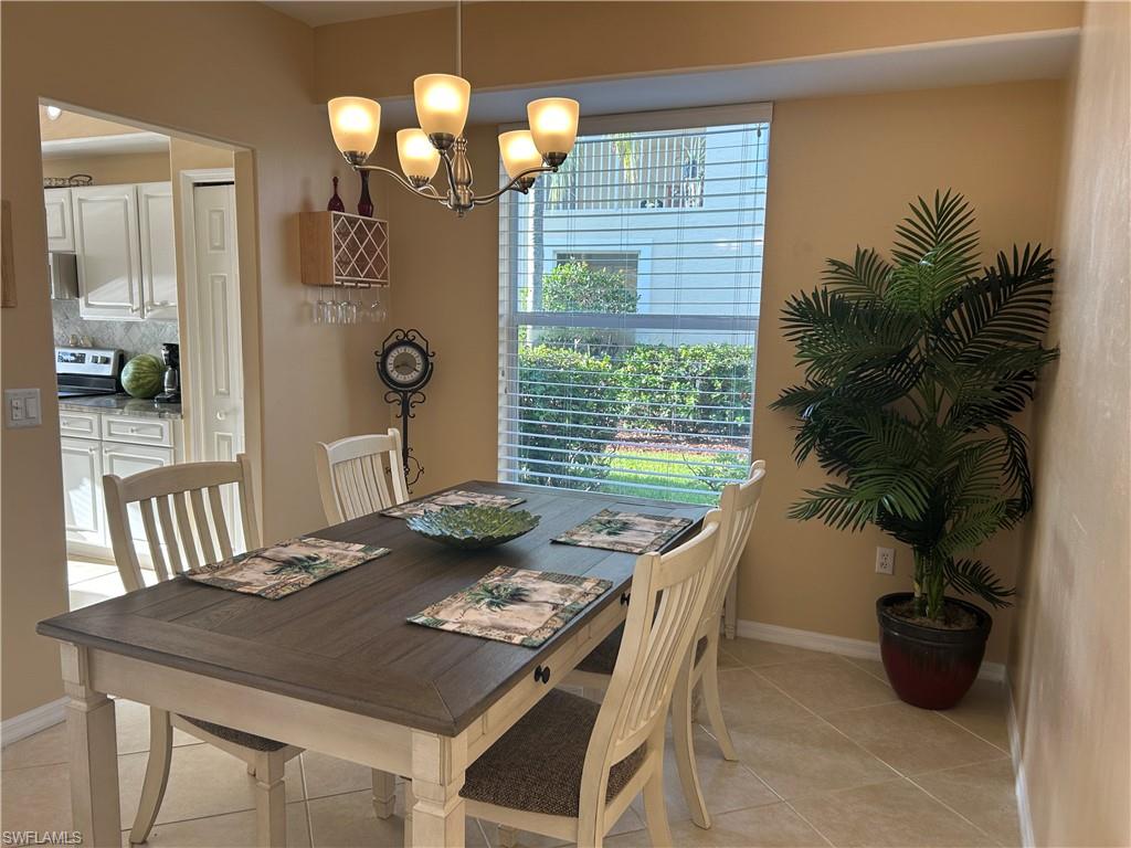 1390 Tiffany Lane, Unit 2302 Naples, FL 34105 - Photo 12 of 37 a view of a dining room with furniture and window