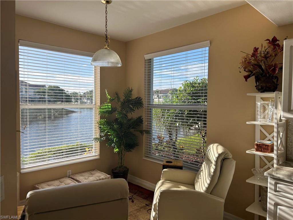 1390 Tiffany Lane, Unit 2302 Naples, FL 34105 - Photo 15 of 37 a living room with furniture and a window
