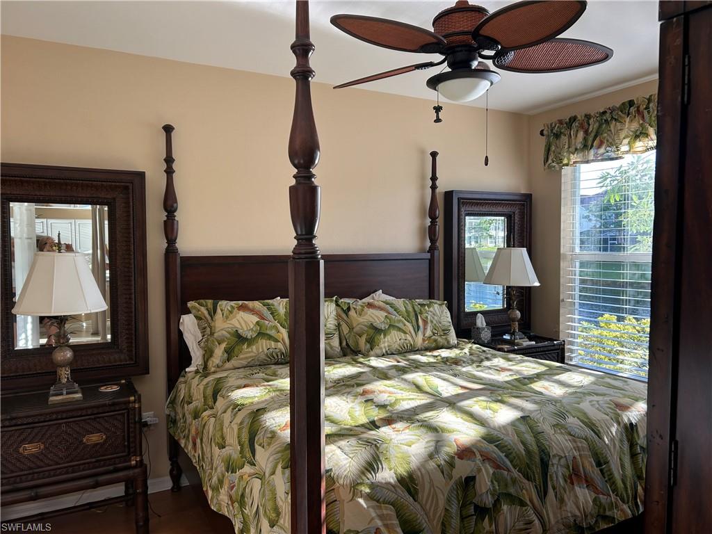 1390 Tiffany Lane, Unit 2302 Naples, FL 34105 - Photo 16 of 37 a bedroom with a bed ceiling fan and a window