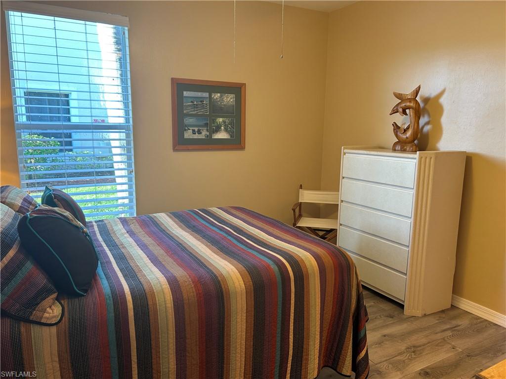 1390 Tiffany Lane, Unit 2302 Naples, FL 34105 - Photo 20 of 37 a bedroom with a bed and a window