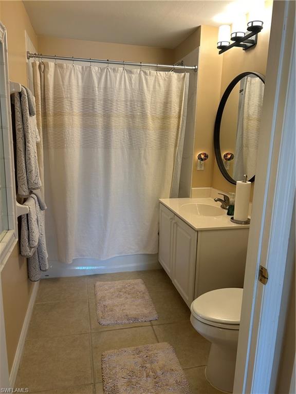 1390 Tiffany Lane, Unit 2302 Naples, FL 34105 - Photo 21 of 37 a bathroom with a sink a toilet and shower