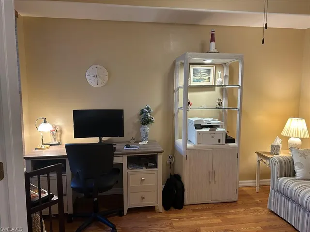 a view of a livingroom with workspace and a window