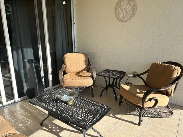 a room with chairs and a rug