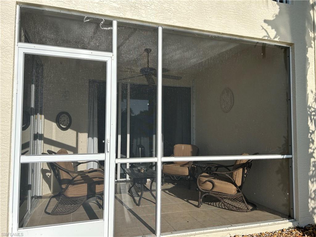 1390 Tiffany Lane, Unit 2302 Naples, FL 34105 - Photo 29 of 37 a balcony with table and chairs