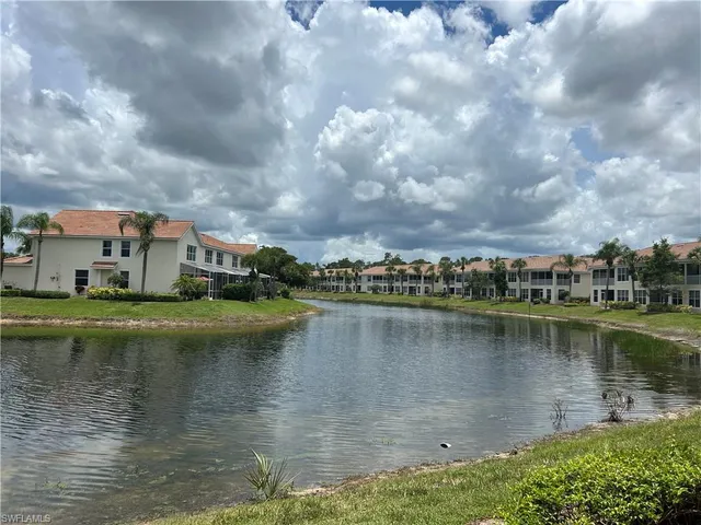 a view of a lake with houses in the background